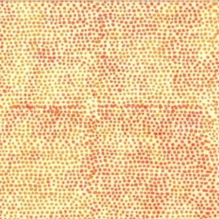 Batik fabric with scattered red and orange dot motif on cream background