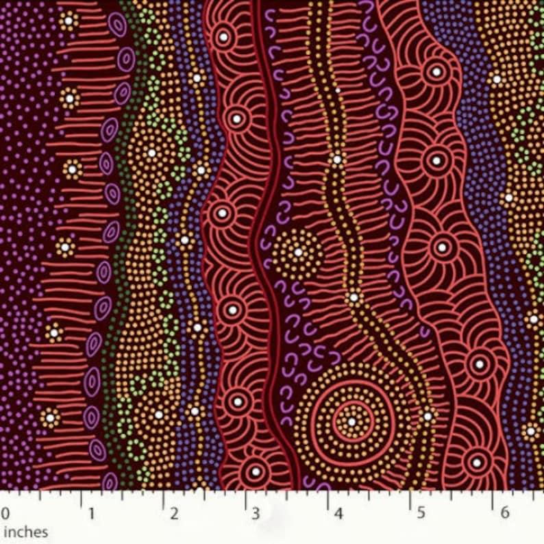 Burgundy batik fabric with concentric circles and dotted line motifs
