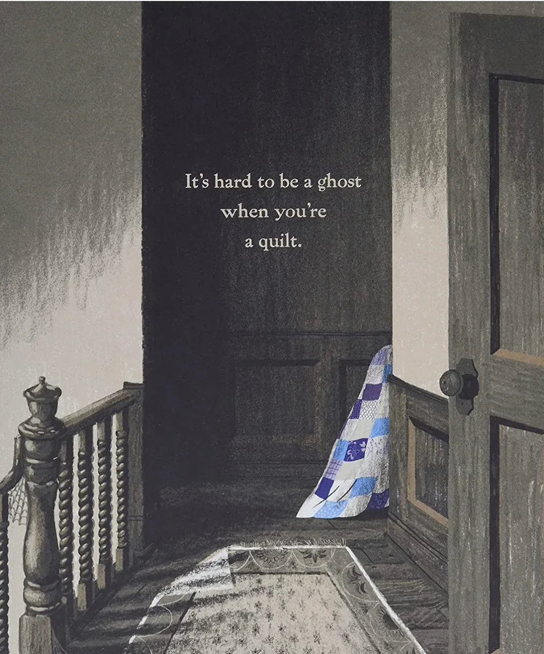 Blue-and-white patchwork ghost quilt draped on floor, hood pointing down.