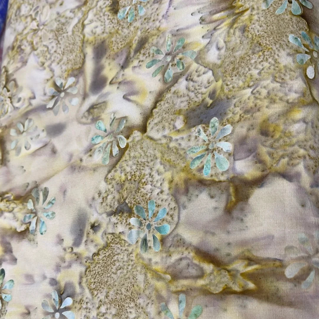 Batik fabric with sea-blue and tan flower and spot pattern on light base