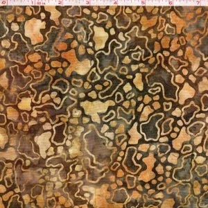 Batik fabric with intricate geometric pattern in dark brown and tan