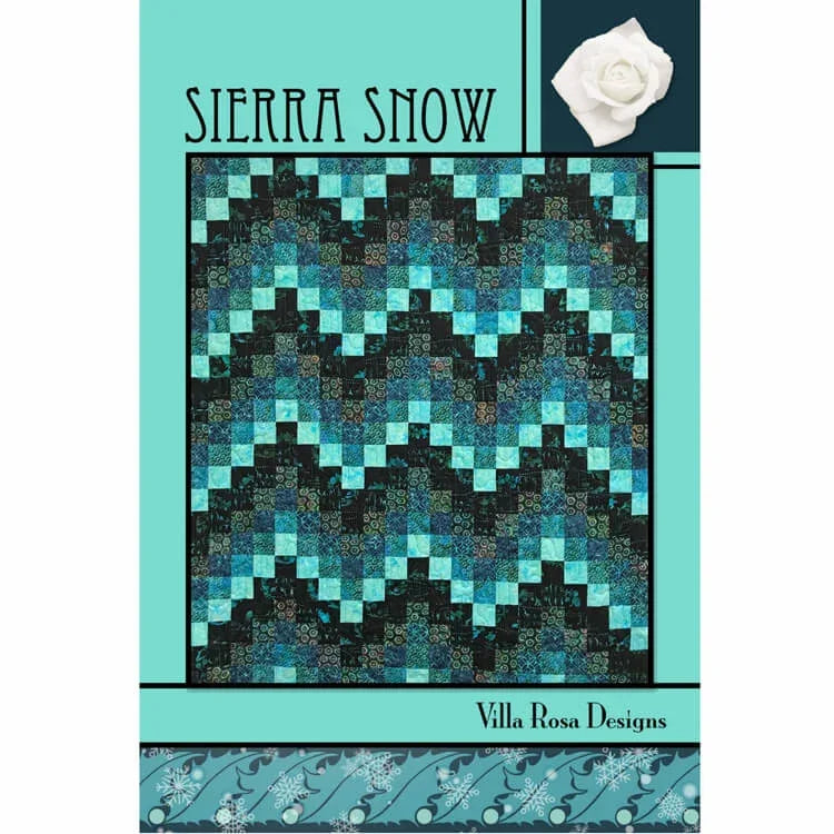 Quilt fabric panel with teal, black, and white geometric snowflake pattern.