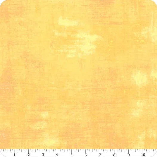 Peach cotton fabric with distressed grunge texture, with inch ruler at bottom