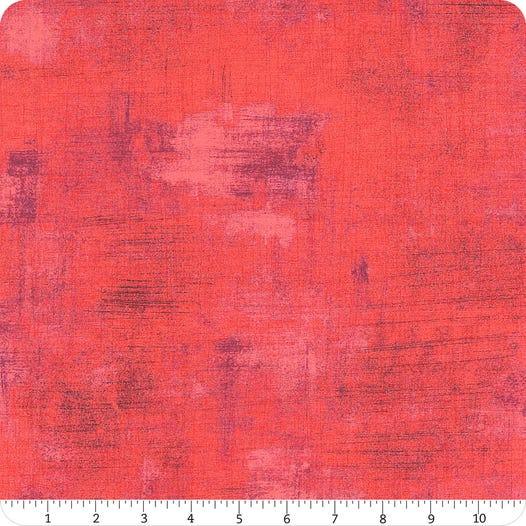Grunge fabric swatch with red and pink mottled texture