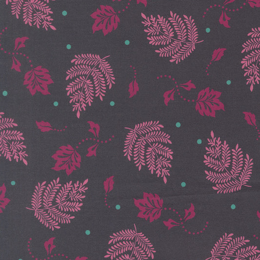 Paisley leaf fabric swatch with magenta and teal botanical pattern on dark gray