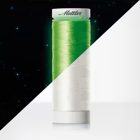 Mettler Poly Glow 40 wt thread spool with a bright green upper half and white lower half