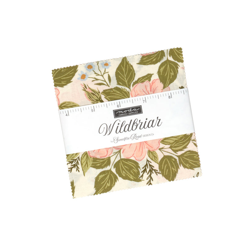 Wildbriar Charm Pack of 5-inch floral fabric squares, wrapped with a paper label