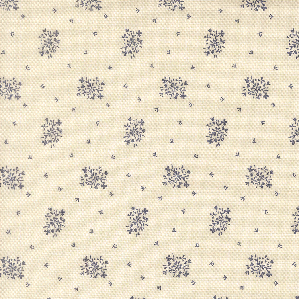 Wildbriar Porcelain quilting fabric with a cream ground and scattered blue floral sprigs