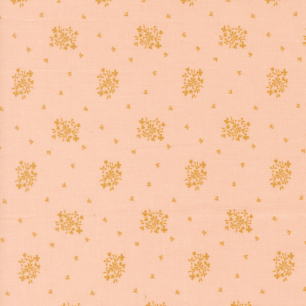 Wildbriar blush fabric with a repeating gold floral and sprig print