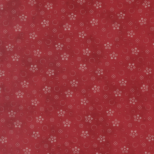 Crimson cotton fabric with scattered snowflakes and small dotted circles pattern