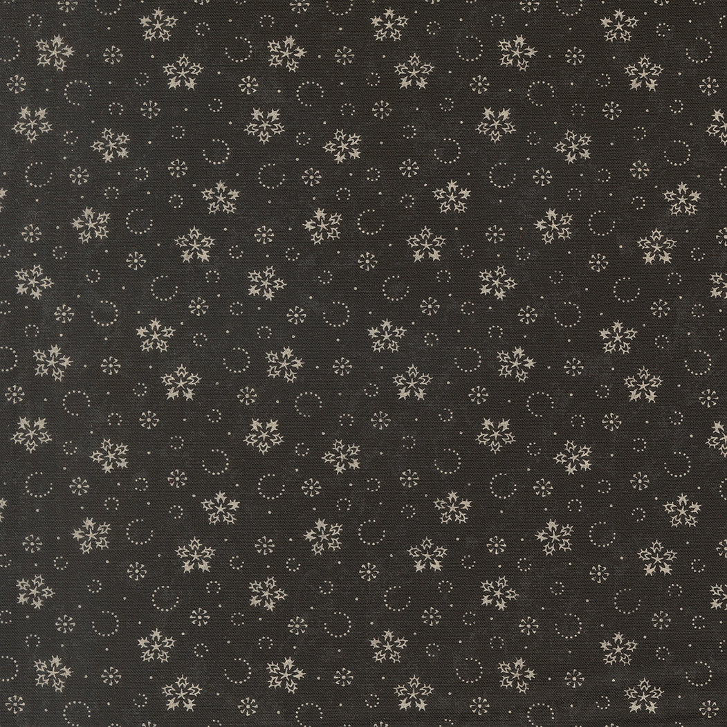 Ebony fabric with scattered gold snowflakes, circles, and small star motifs