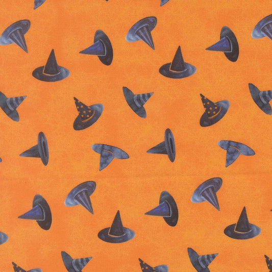 Orange fabric with scattered black and gray witch hats
