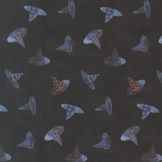 Dark fabric with scattered witch hat motifs in blue and purple with small orange accents