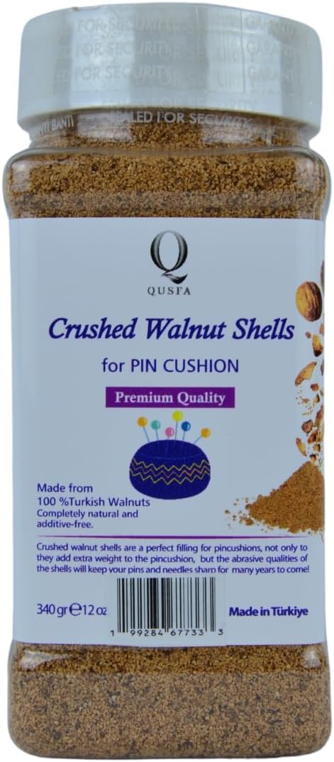 Crushed walnut shells filler in a clear jar with white lid, fine brown powder