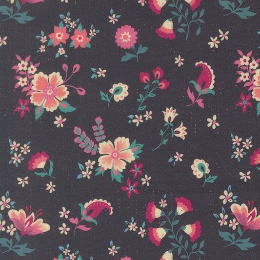 Floral quilting fabric with dark blue background and scattered multicolor flowers