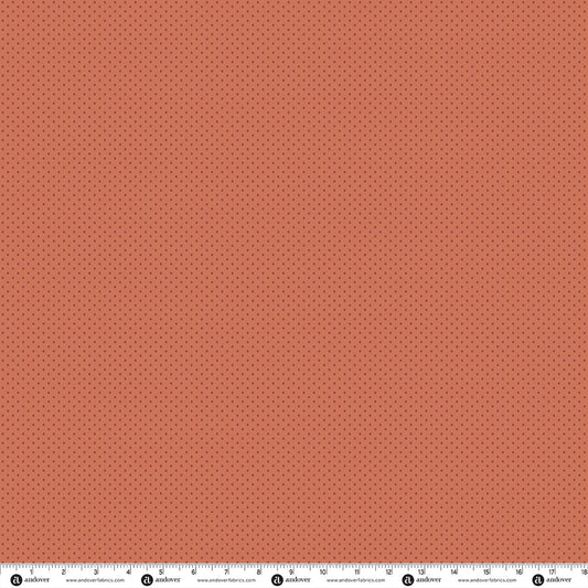 Peach cotton fabric with small scattered dark dots pattern