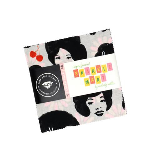 Sparkle Mart charm pack wrapped in a band, with fabric squares printed with faces and cherries