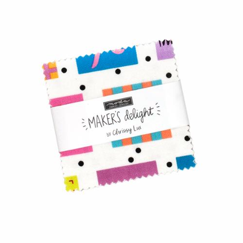 Moda Makers Delight fabric charm pack wrapped in a label, with a white ground and colorful geometric prints