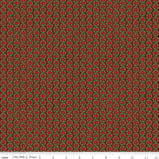 Christmas quilting fabric in red with repeating green star pattern