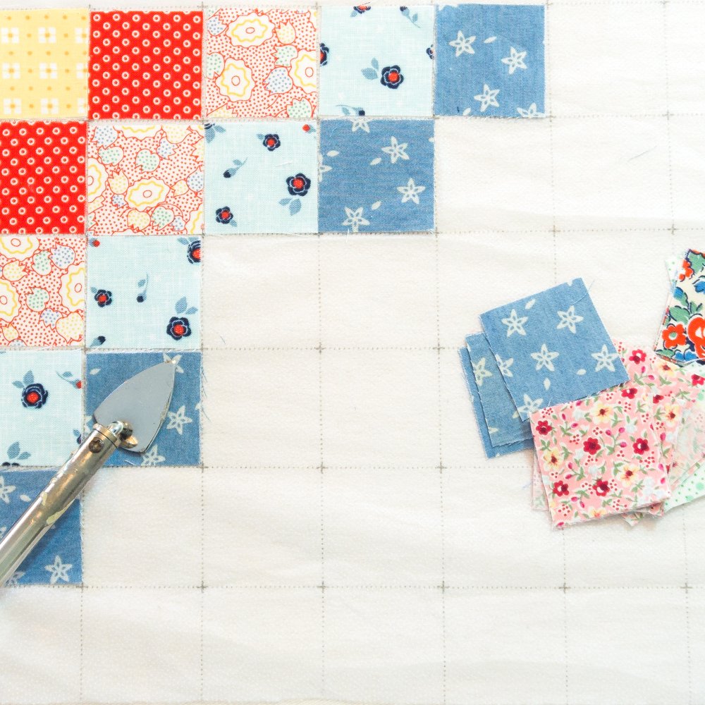 Assorted quilt fabric grid panels with red, pink, and blue patterned squares