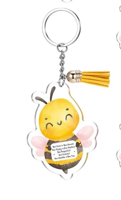 Bee-themed keychain with silver key ring, tassel, and smiling yellow bee charm