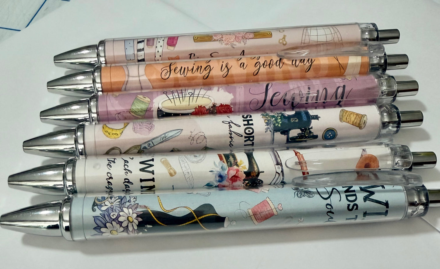 Sewing-themed pen set with colorful printed designs and shiny metal tips