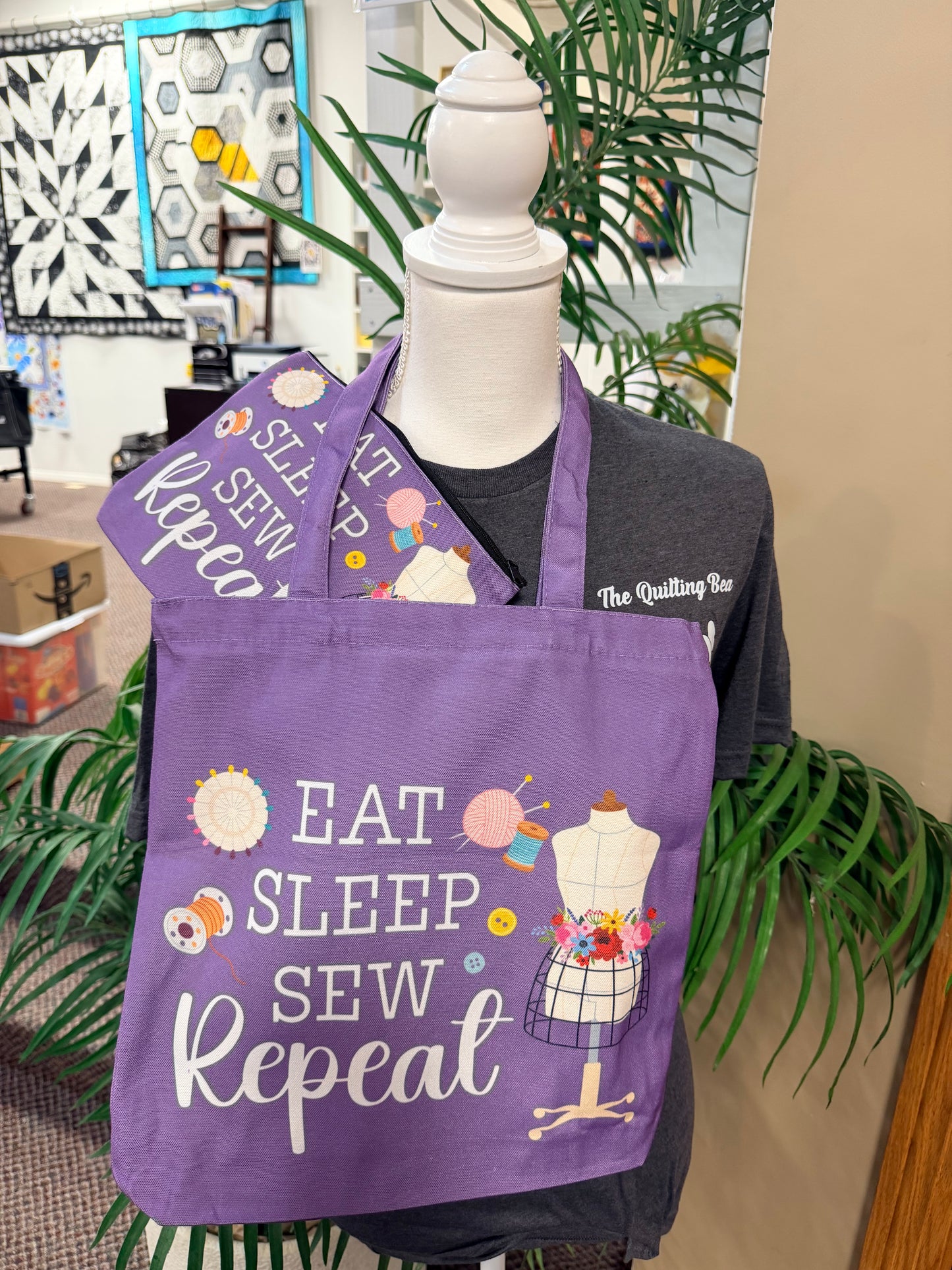 Purple canvas tote bag with "Eat Sleep Sew Repeat" sewing-themed print