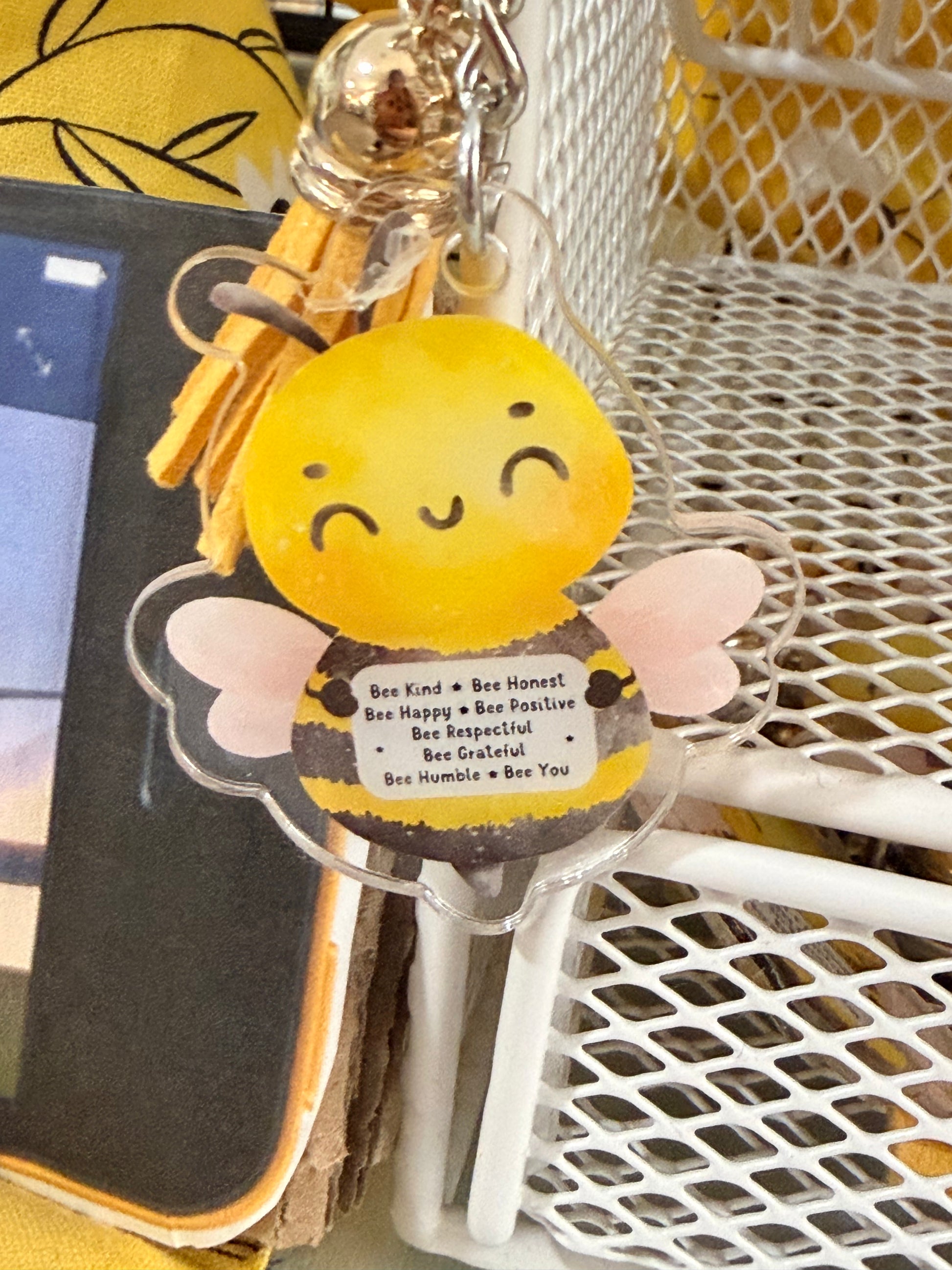 Bee keychain with yellow bee charm, pink wings, and silver ring with tassel