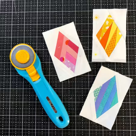 Mini Diamonds foundation paper piecing pad shown with three colorful fabric diamond blocks