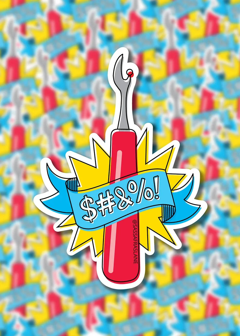 Seam ripper humor sticker with red handle, yellow starburst, and bold '$#%!&!' text