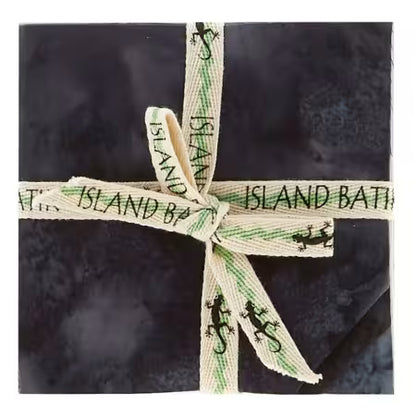 5-inch charm pack of black batik fabric squares, tied with green ribbon