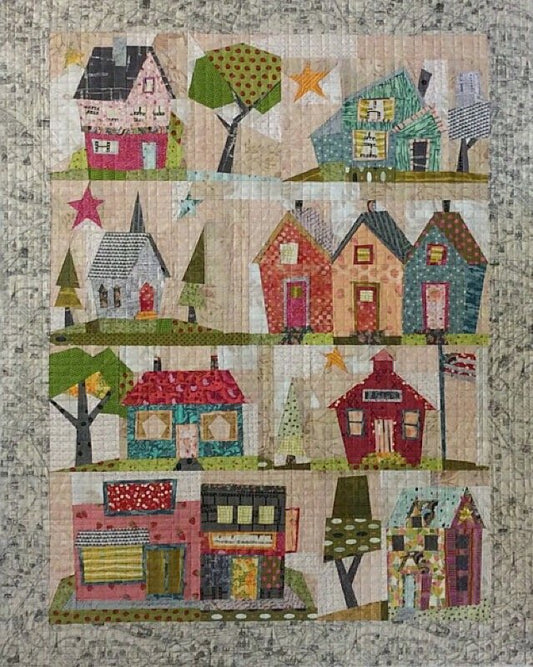 Foundation paper piecing quilt pattern with colorful house blocks, stars, and trees